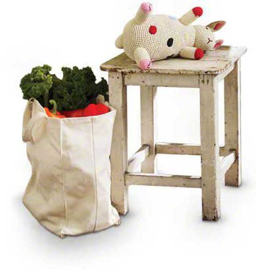 stool with stuffed toy cow and bag of groceries