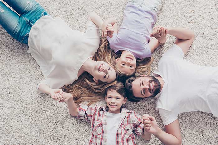 family on newly installed carpet